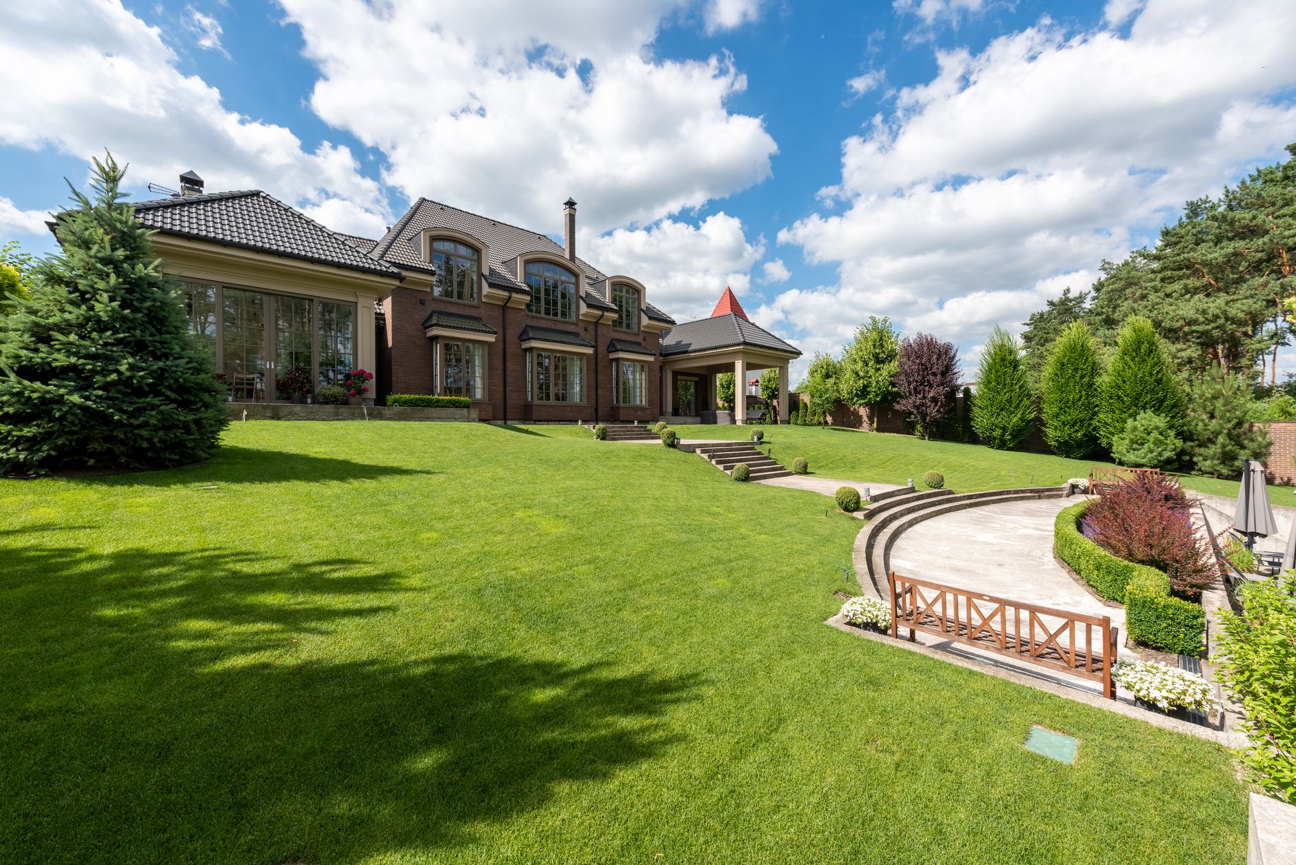 Two acres renewed in phases. Estate grounds, no drama.